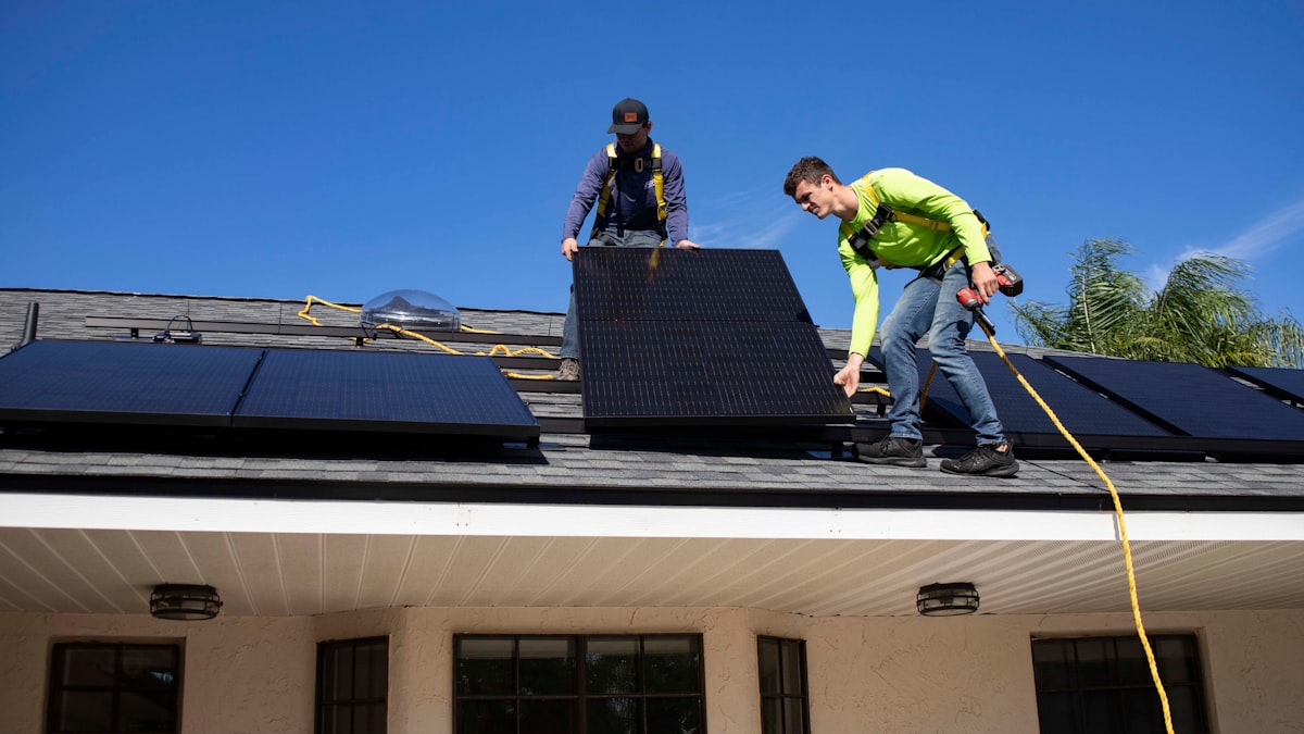 Workers installing solar panels